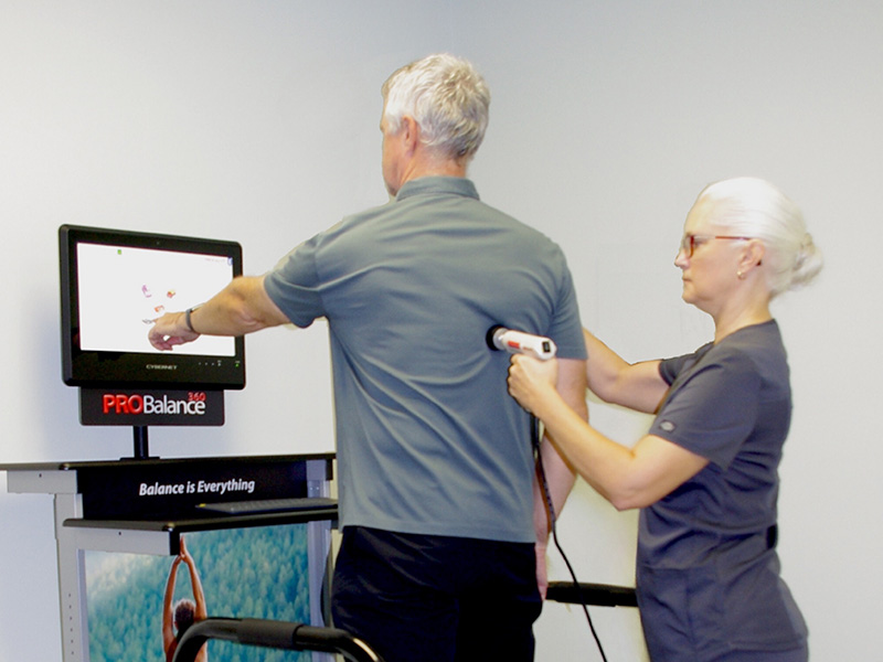 Dr Karen using Pro Balance machine on patients back