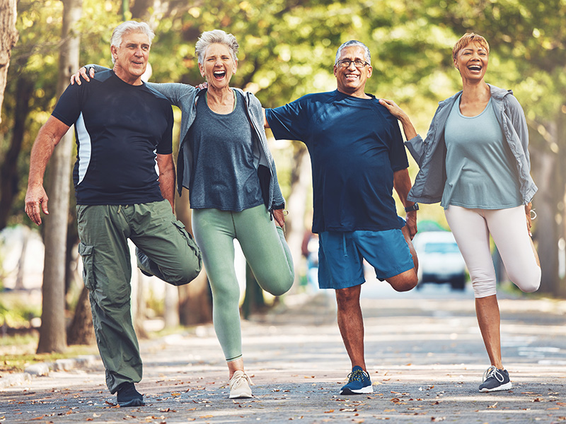 Group of older men and woman stretching before a run