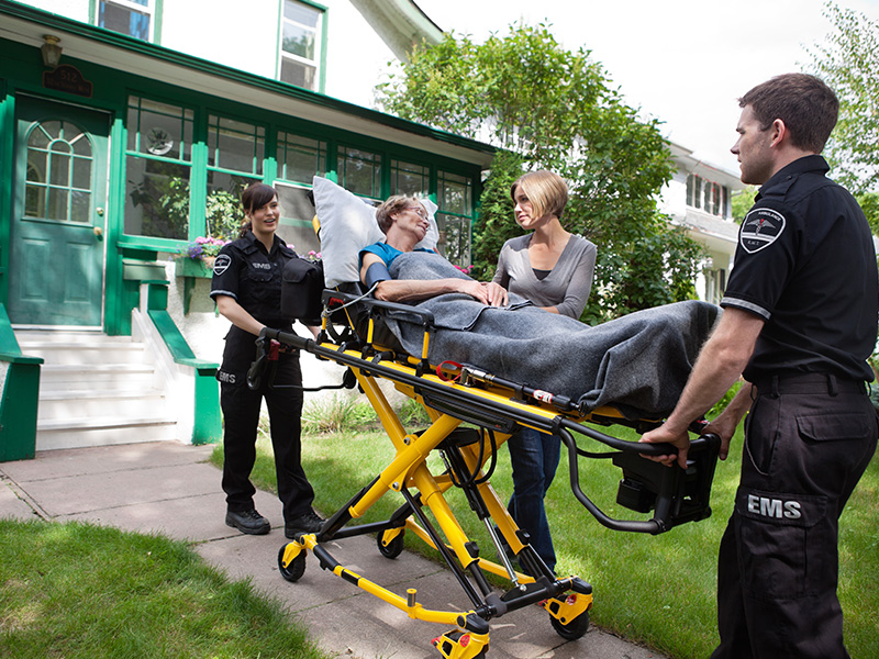 Woman on stretcher with medics